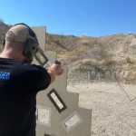 Man shooting gun in open range