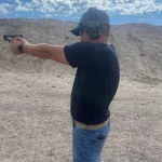 man shooting gun side view