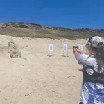 Woman learning to shoot gun