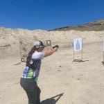 Womanlearning to shoot gun
