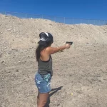 Woman learning to shoot gun